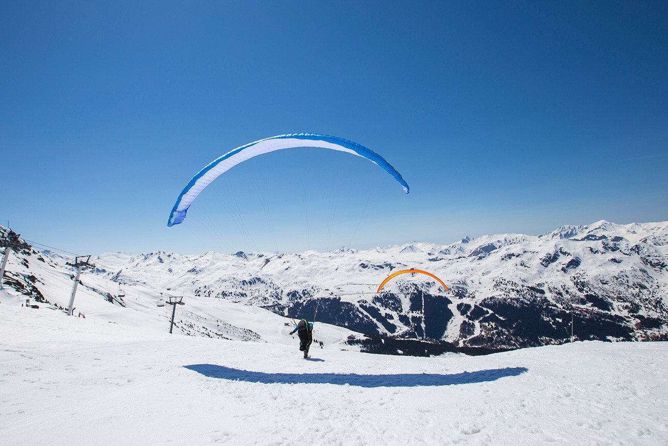 Parapente au-dessus des vallées enneigées